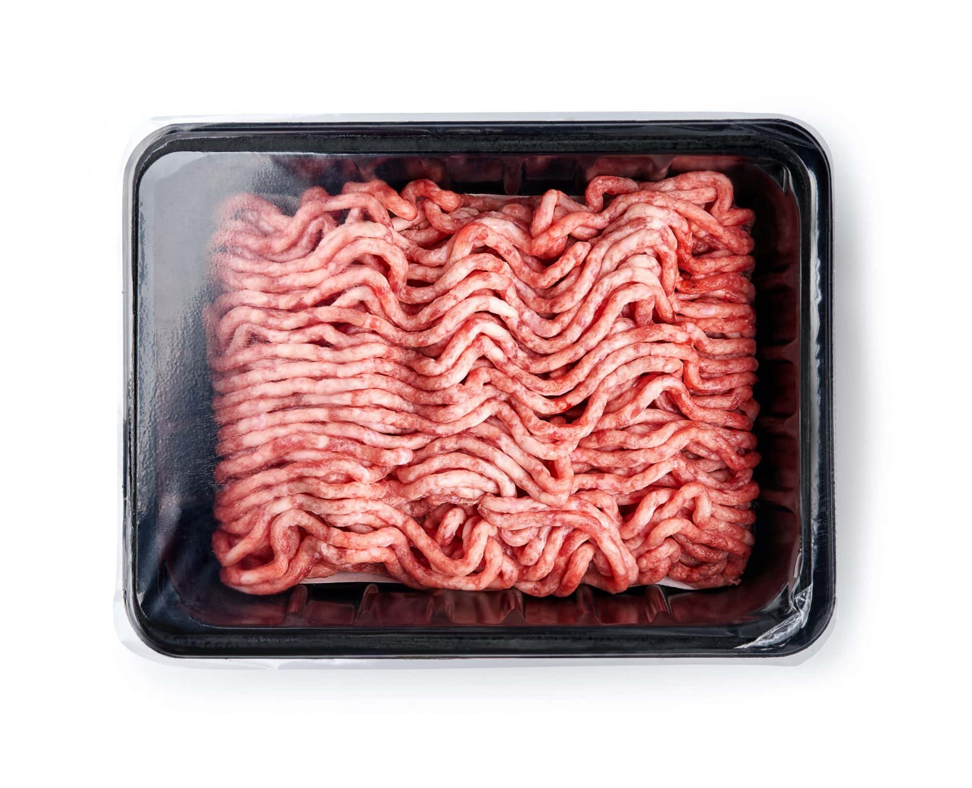 Plastic tray with raw fresh pork minced meat on white background. Packaging design for mock up.